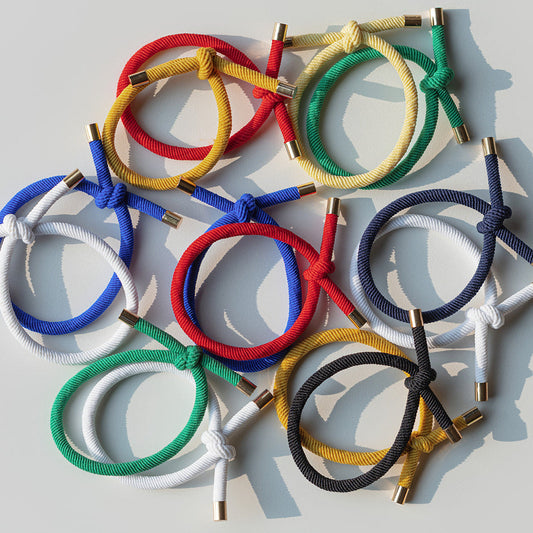 Colorful braided Hair Ties on a light gray background