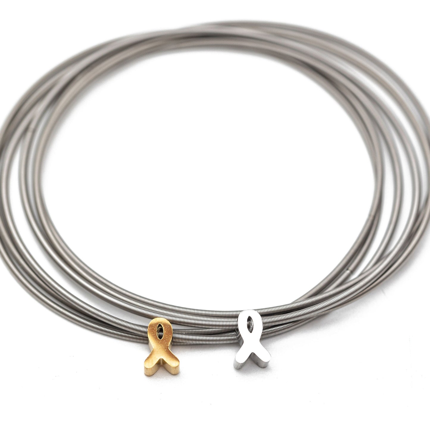Stainless steel DIA Bracelets with a gold and silver ribbon charm on a white background