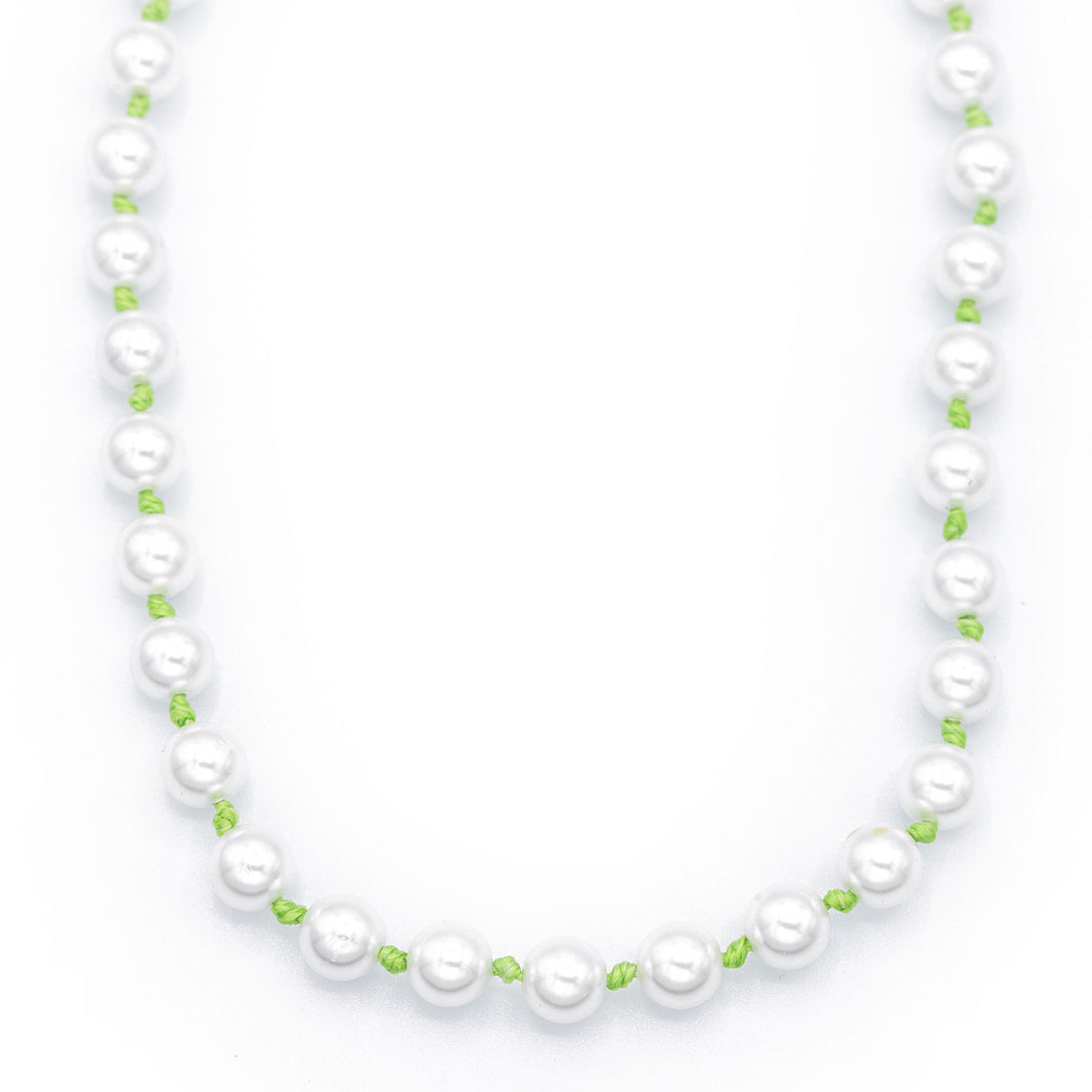 Pearl necklace with green beads on a white background