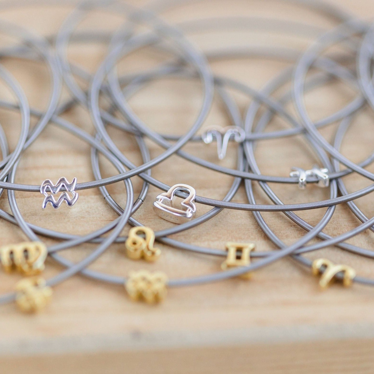 A group image of gold and silver zodiac charms