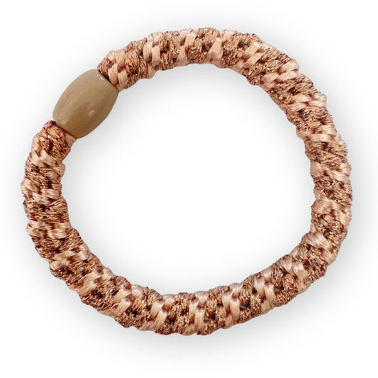 Textured hair tie  with a beige bead on a white background