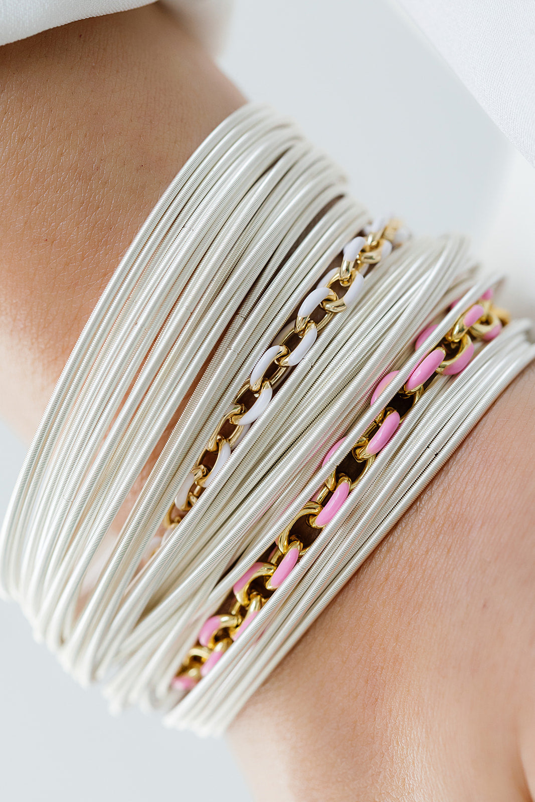 STerling DIA stacked with enamel chain bracelets on a model
