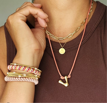 Woman wearing DIA bracelets and 2 hair ties on her wrist. 