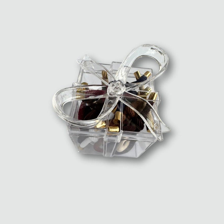 Clear hexagonal container with a bow on a white background