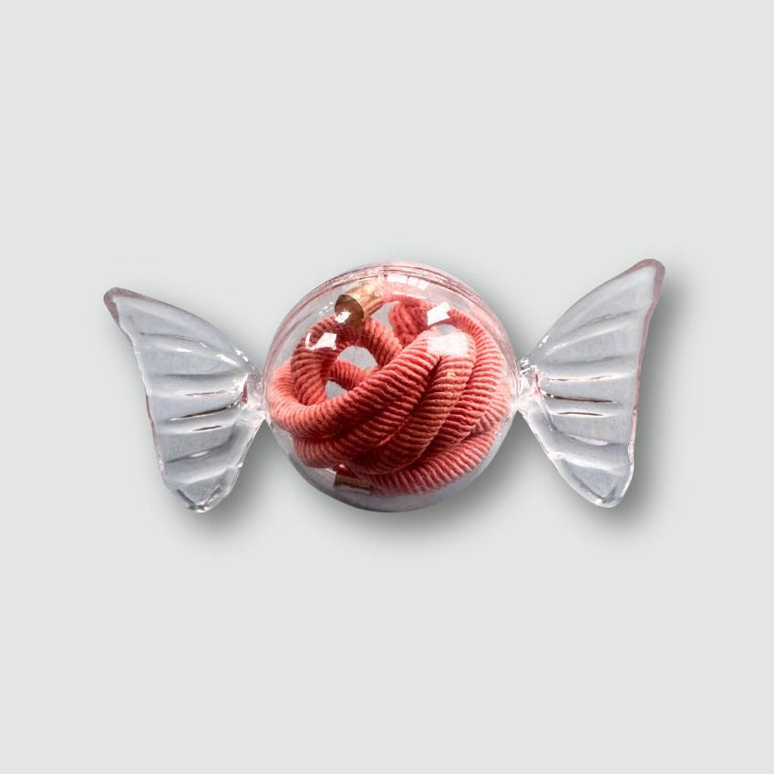 Pink corded toy with clear wings on a light gray background