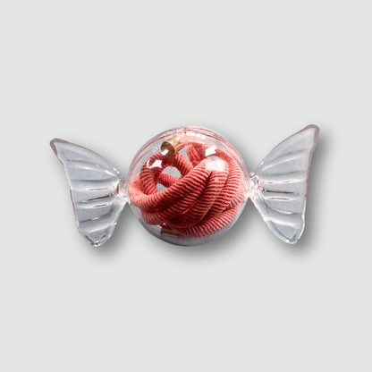 Pink corded toy with clear wings on a light gray background
