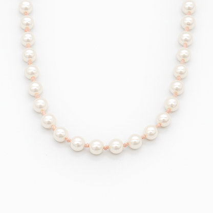 hand knotted shell Pearl necklace on a white background