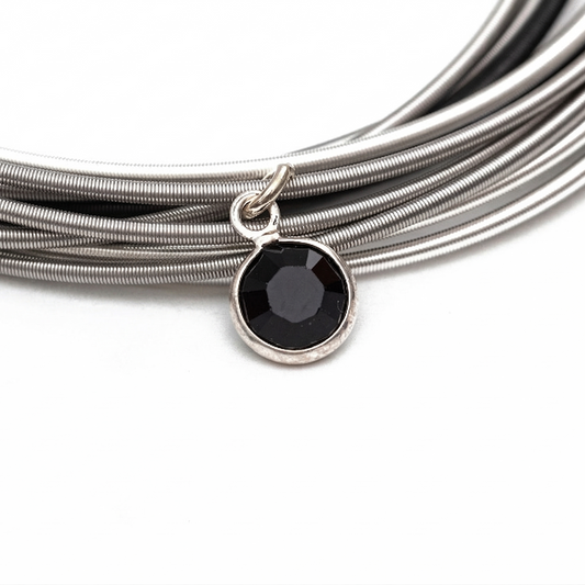 Bracelet with a black pendant on a white background