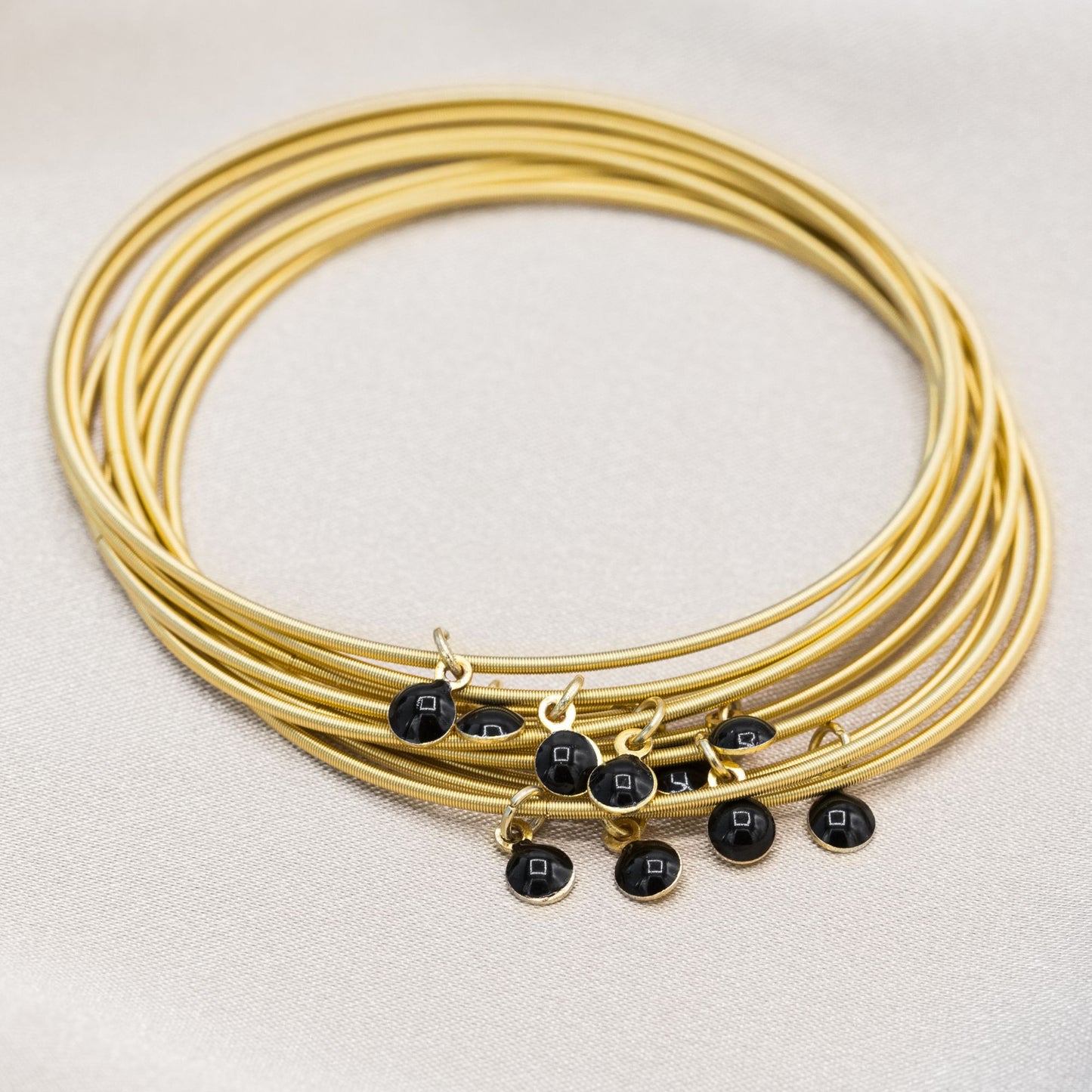 Gold DIA with Black enamel disc charms