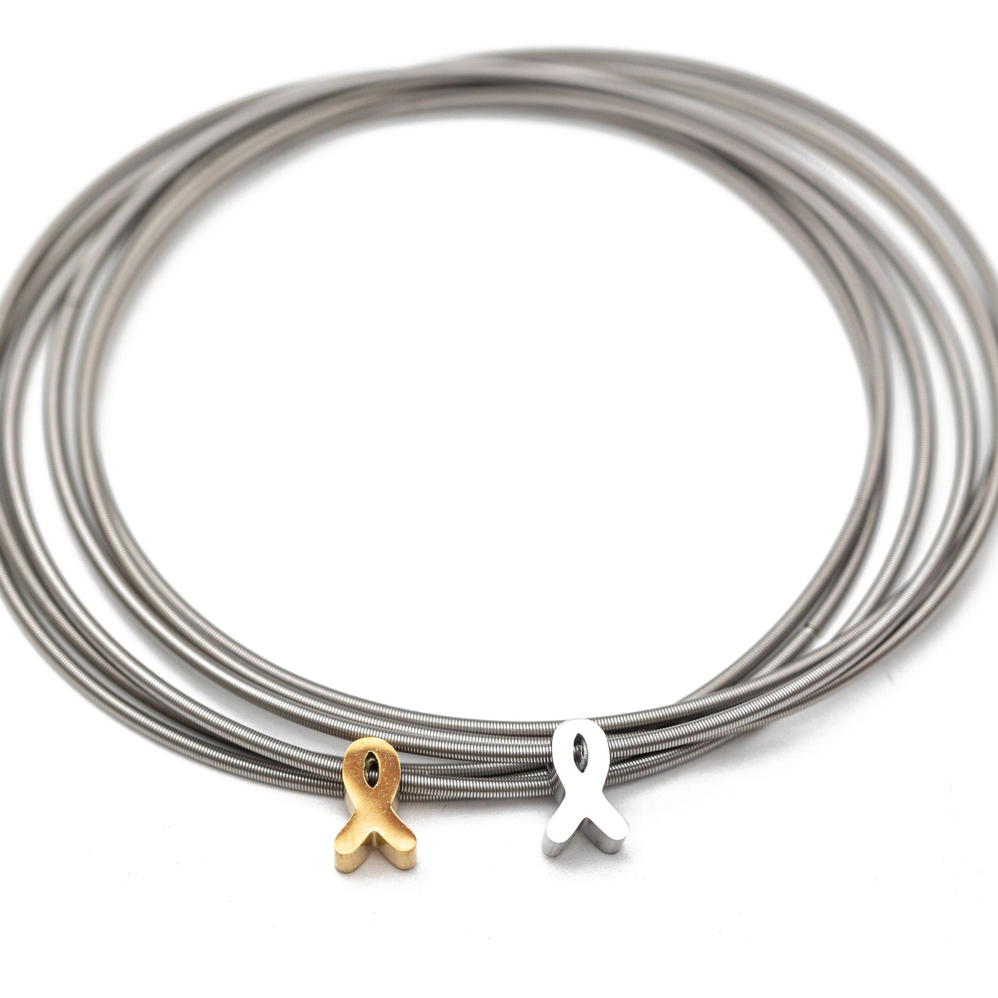 Stainless steel DIA Bracelets with a gold and silver ribbon charm on a white background
