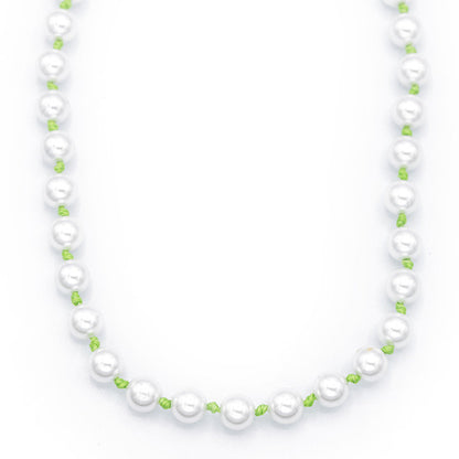 Pearl necklace with green beads on a white background