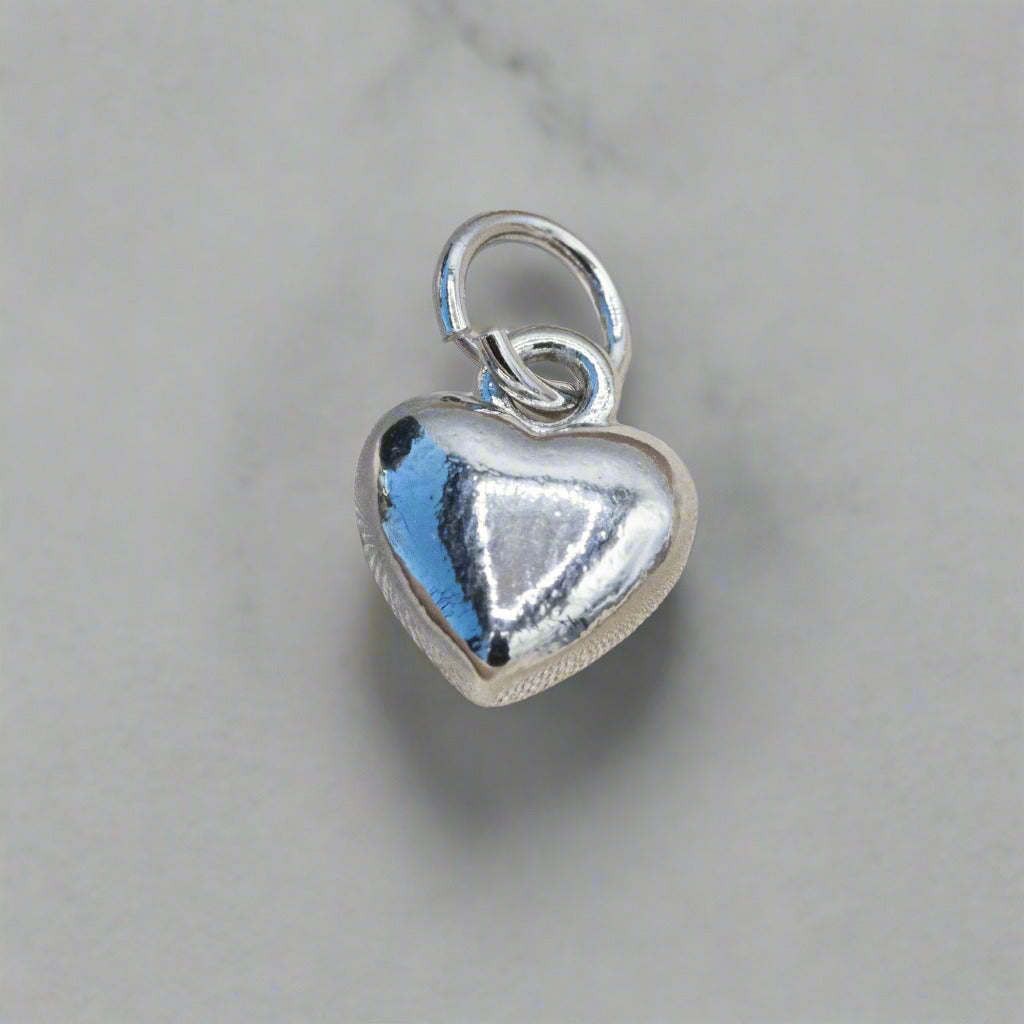 Silver puff heart charm