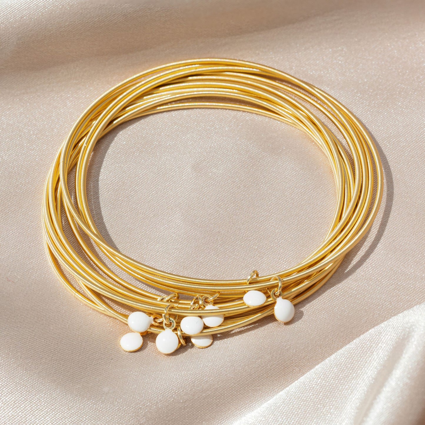 White Enamel Discs on Gold Dia Bracelets
