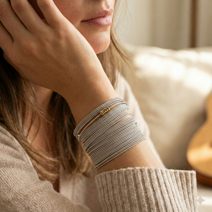 Woman wearing multiple bracelets on her wrist with a blurred background