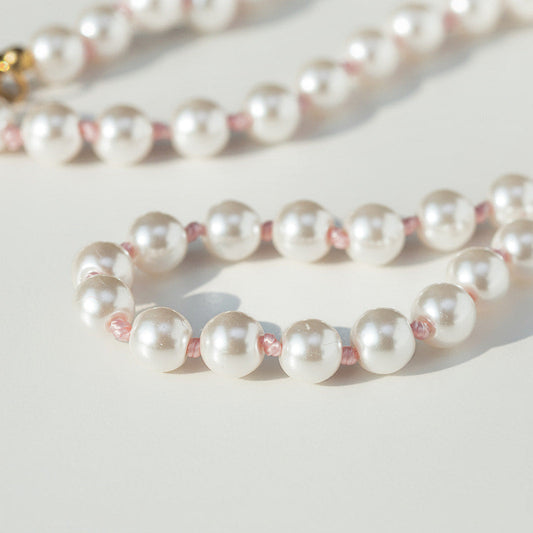 pink hand knotted Pearl necklace on a light background