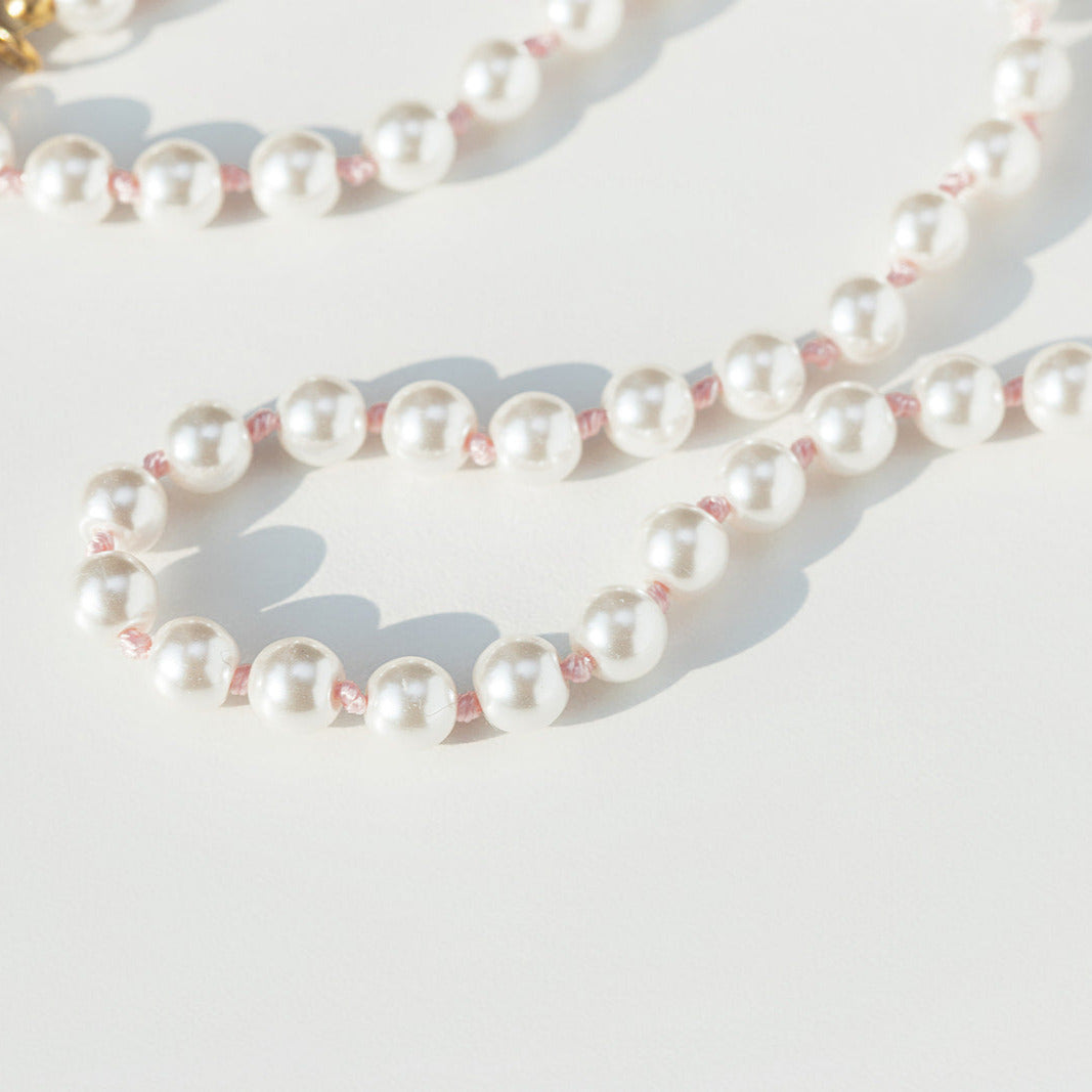 Pearl necklace on a light background pink hand knotted 