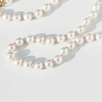 Pearl necklace on a light background pink hand knotted 