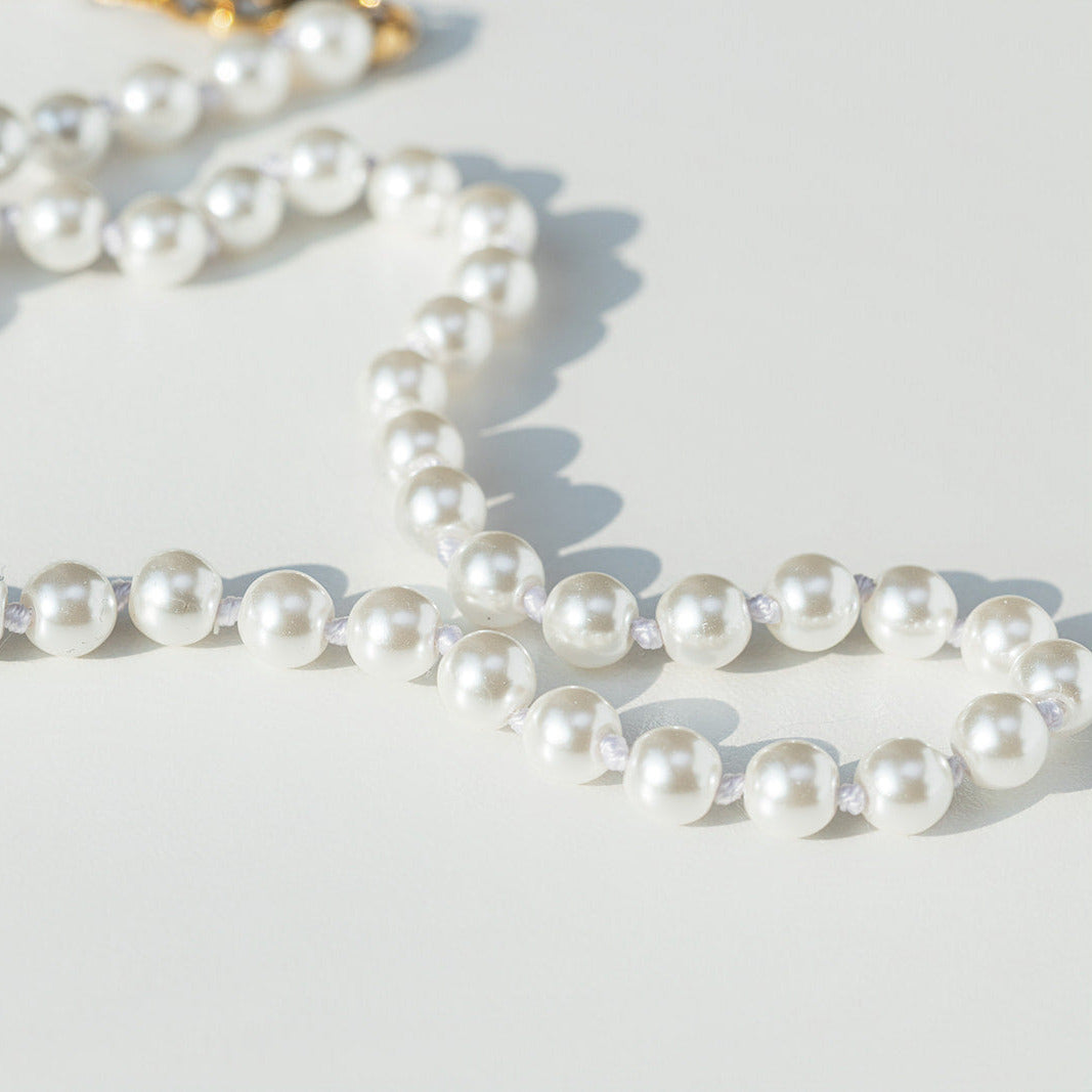 Pearl necklace on a light background
