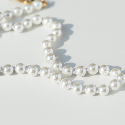 Pearl necklace on a light background