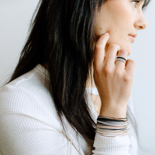 model wearing mixed metal dia rings
