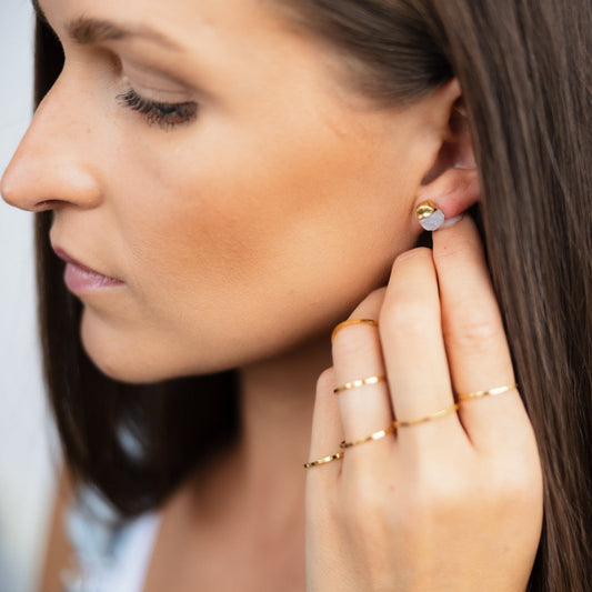 Model wearing gold titanium steel rings