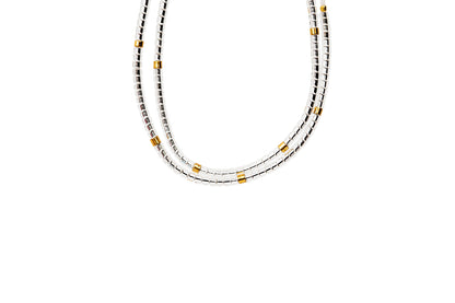 2 tiny beaded bracelets on string. Tiny silver  beads with a few gold beads throughout.